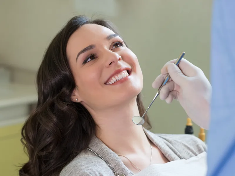 A smiling woman in a dental chair during a checkup
